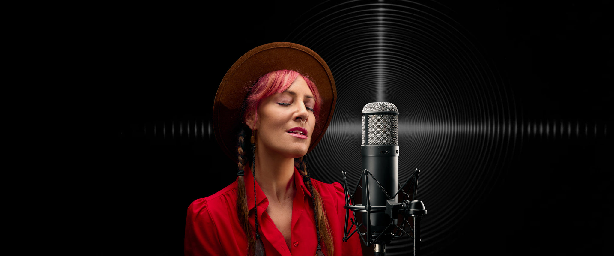 Vocalist sings into a Universal Audio Sphere microphone
