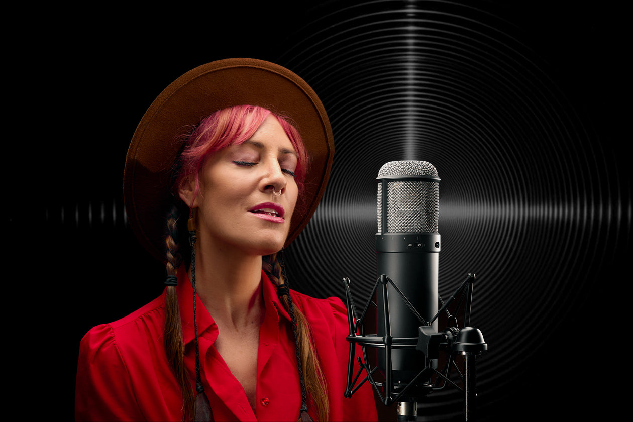 Vocalist sings into a Universal Audio Sphere microphone