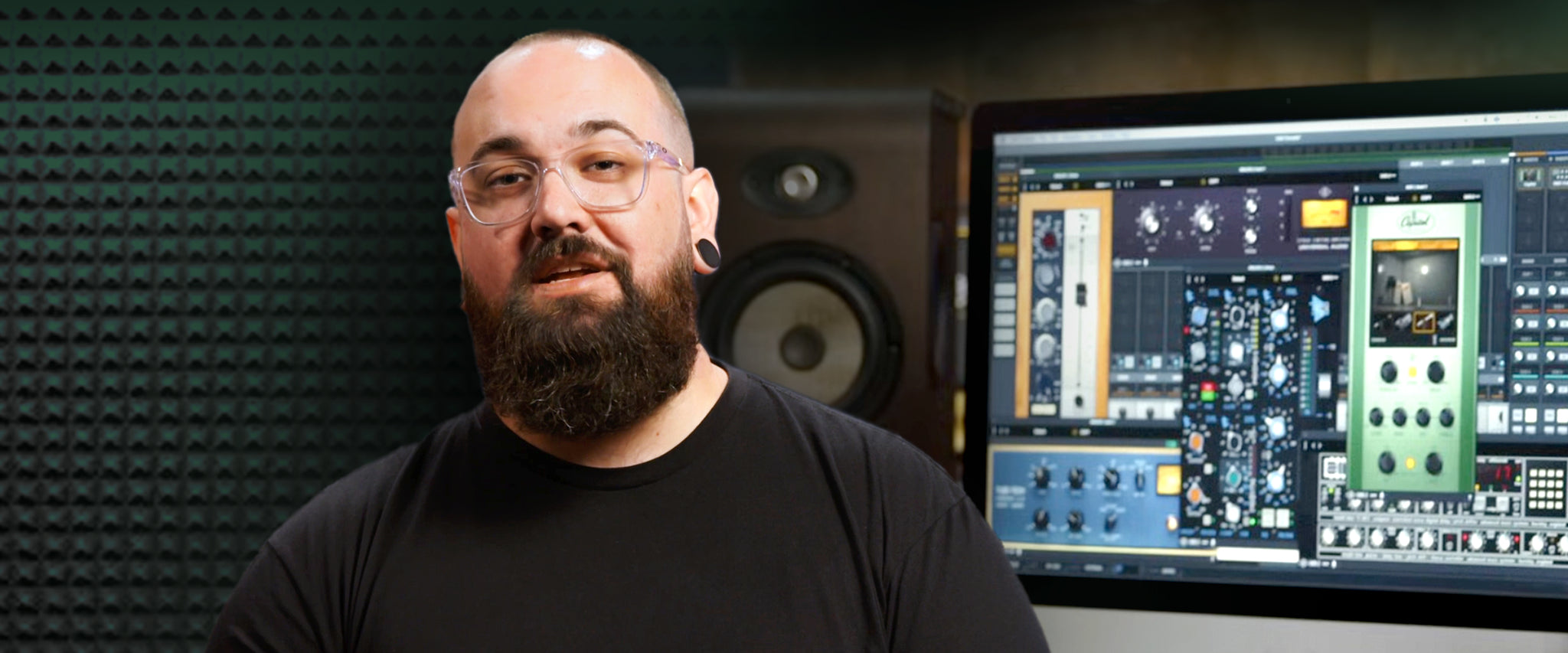 Universal Audio's Matt Petersen sits in front of a computer monitor with many plug-ins 