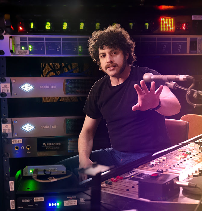 Andrew L. Butler and Eli Gelb sits at vintage recording console